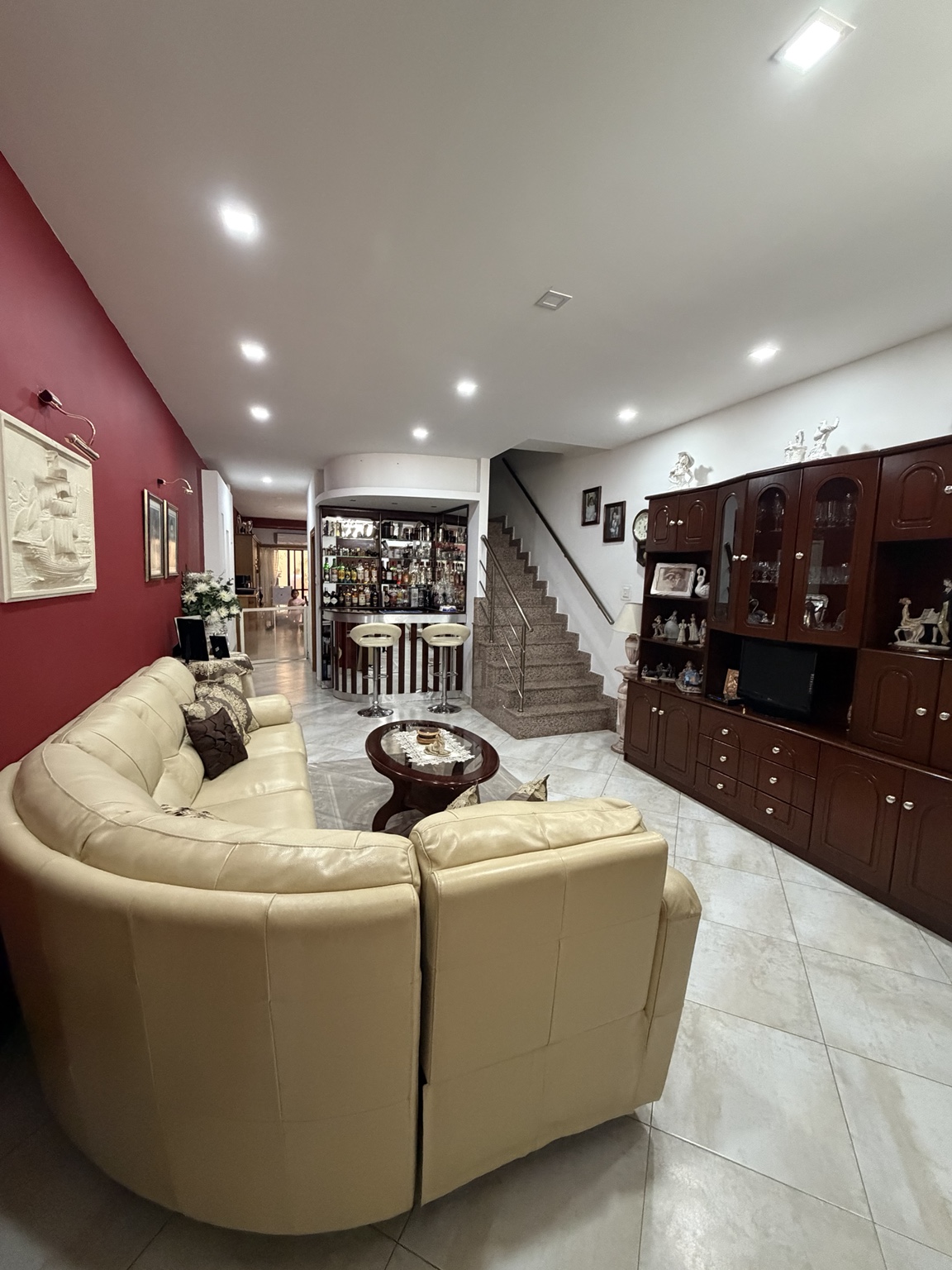 Spacious living room with seating area and staircase